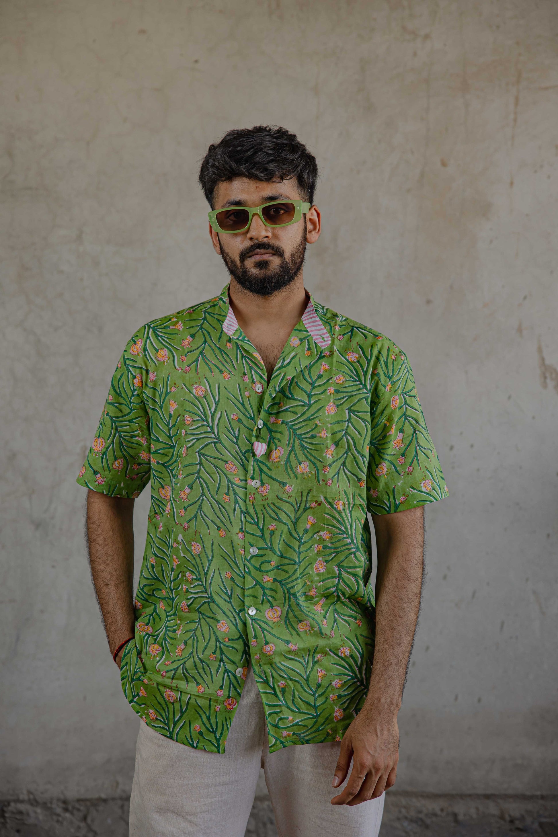 Green poppy floral handblock printed shirt with pink strike collar detailing portrayed